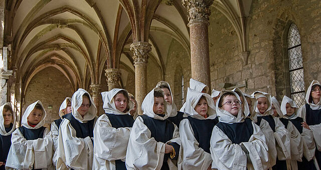 Kleine Mönche auf Zeit erkunden den gotischen Kreuzgang im Zisterzienserkloster